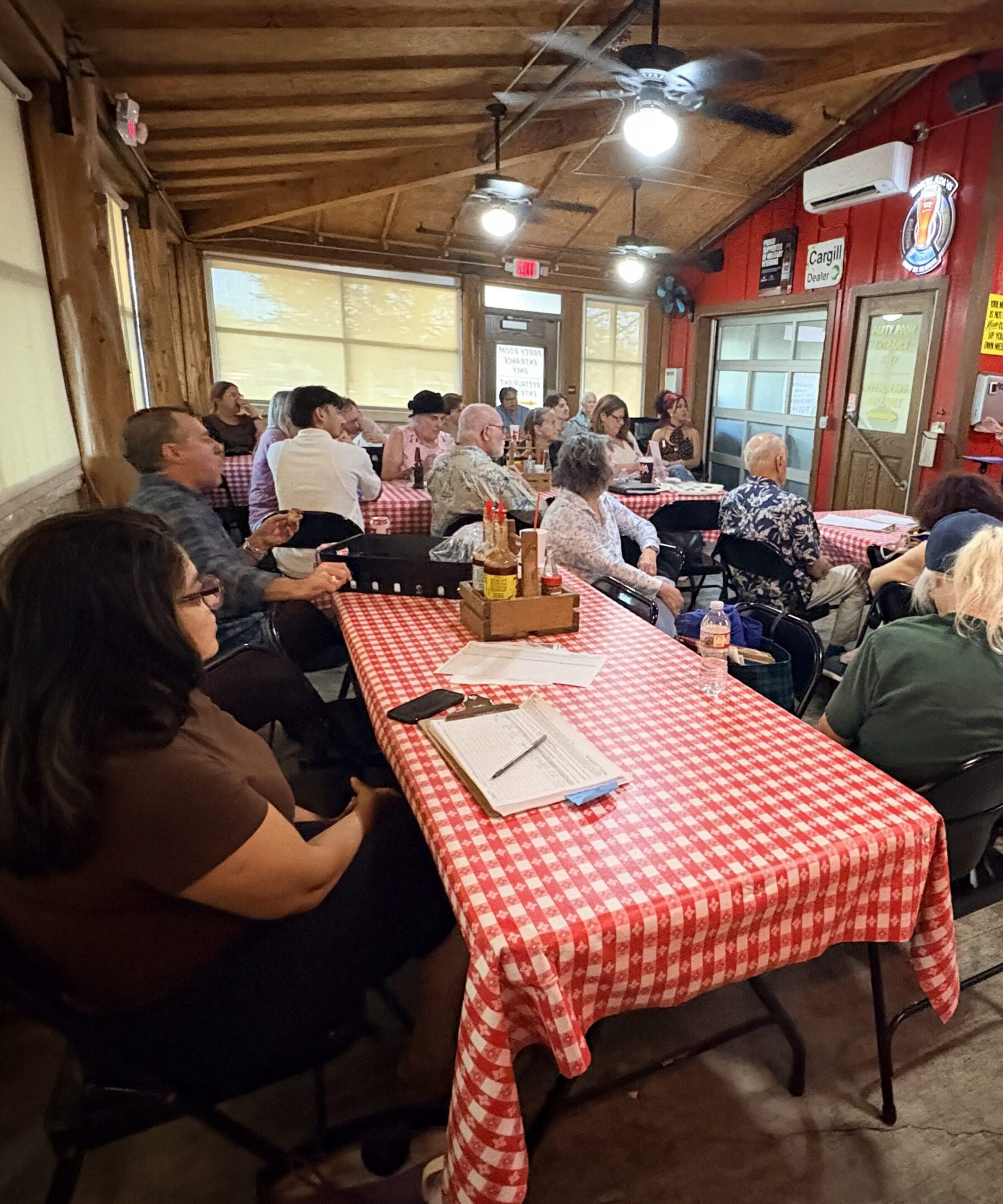 People gathered in a rustic meeting room.
