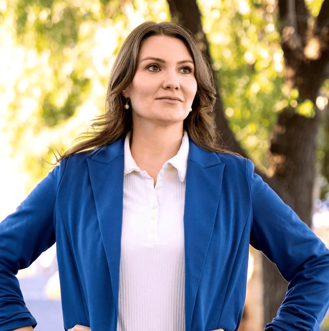 Confident woman in blue blazer outdoors.