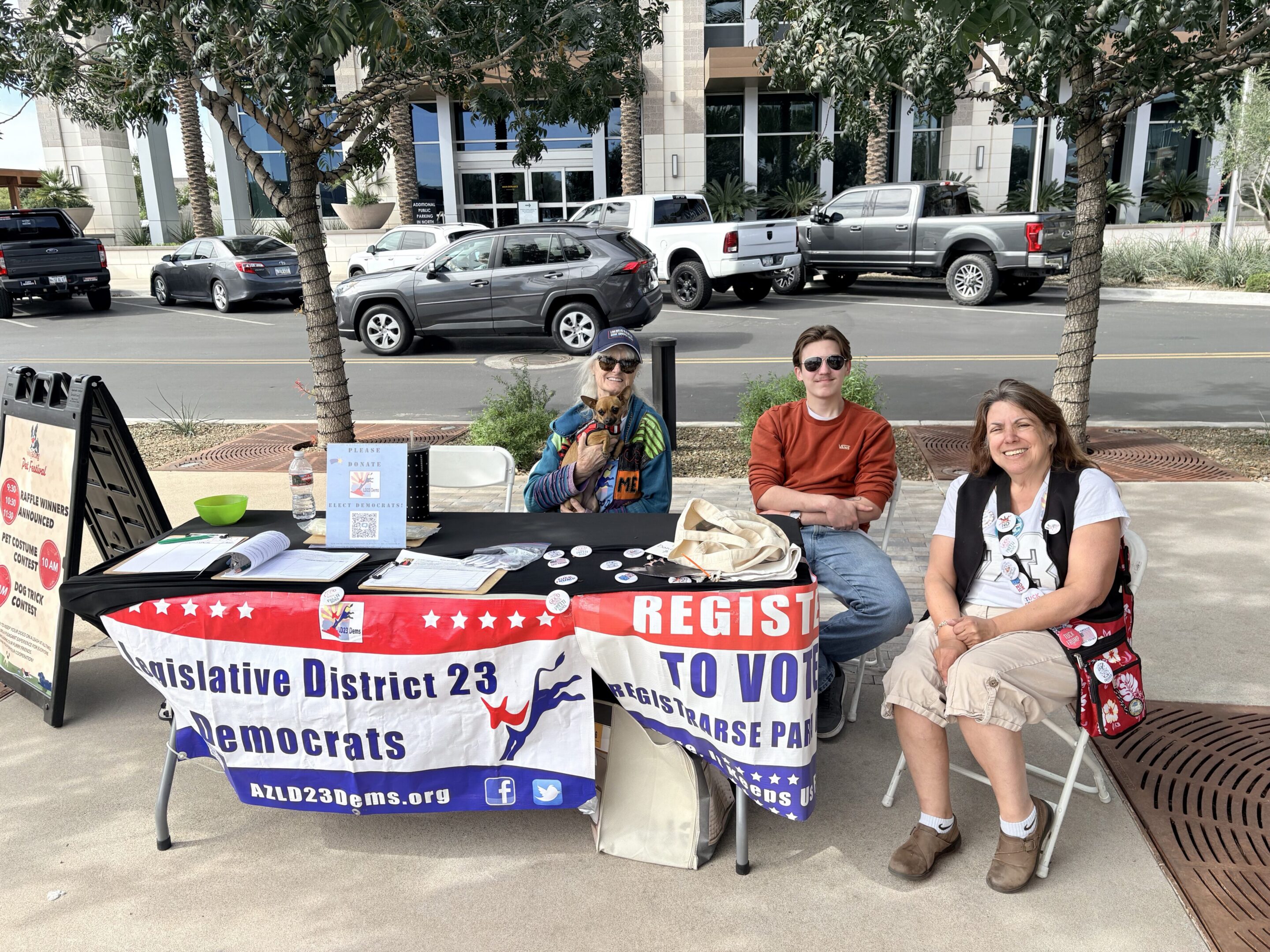 Voter registration booth with three people seated.